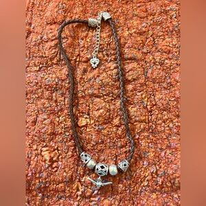 Western lovers braided leather choker necklace with silver charms.